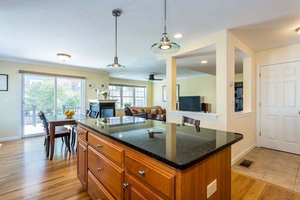 47 Crescent Road, Unit 47 Needham, MA 02494 - Photo 4 of 17 a kitchen with a kitchen island sink stove and wooden floor
