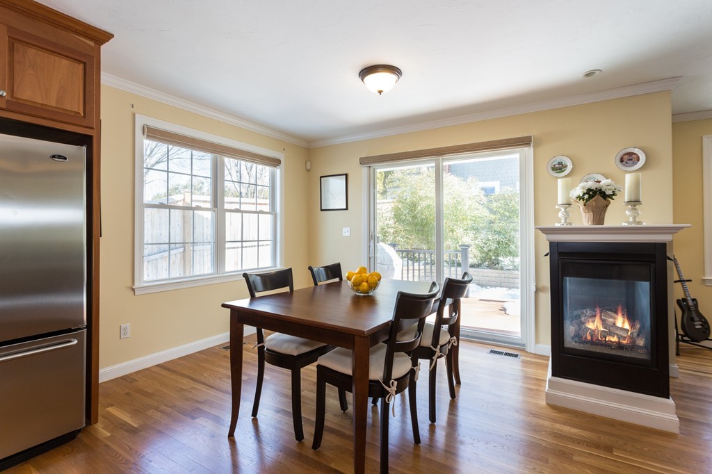 47 Crescent Road, Unit 47 Needham, MA 02494 - Photo 7 of 17 a dining room with furniture a fireplace and wooden floor