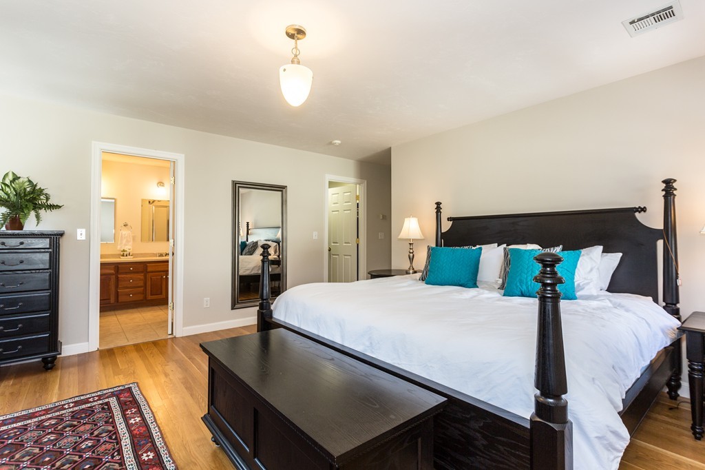 47 Crescent Road, Unit 47 Needham, MA 02494 - Photo 9 of 17 a bedroom with a bed and wooden floor