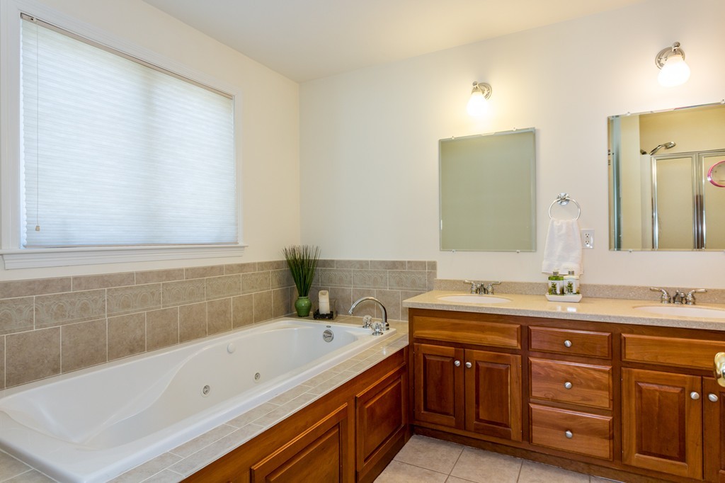 47 Crescent Road, Unit 47 Needham, MA 02494 - Photo 10 of 17 a bathroom with a tub sink and mirror