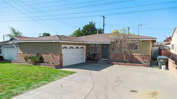 a view of a house with a yard and sitting area