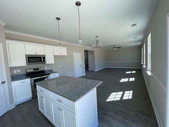 1502 Jack Davis Road Monroe, NC 28112 - Photo 5 of 18 a kitchen with stainless steel appliances granite countertop a sink a stove and a refrigerator