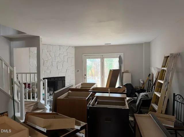 a view of a hallway with furniture and floor to ceiling window