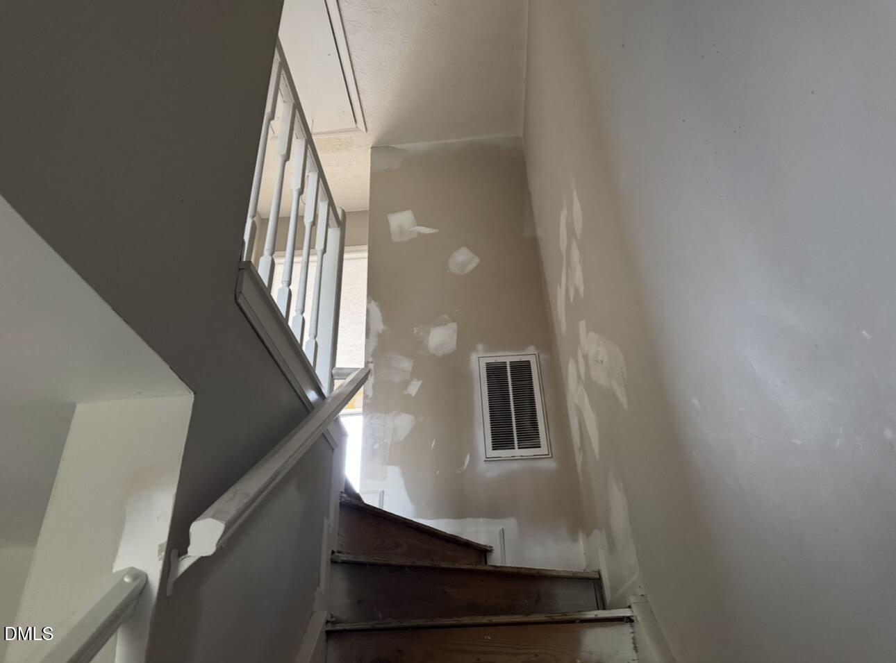 8147 McGuire Drive Raleigh, NC 27616 - Photo 10 of 19 a view of staircase with lots of frames on wall and windows