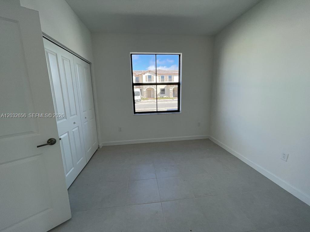10144 Southwest 228th Terrace Miami, FL 33190 - Photo 19 of 23 an empty room with a window