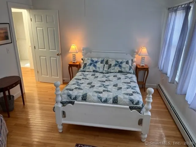a room with bed and wooden floor