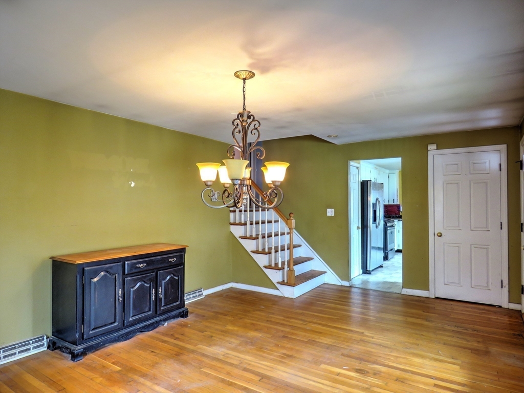 24 Estes Road Hanover, MA 02339 - Photo 6 of 27 a view of a livingroom with wooden floor and staircase
