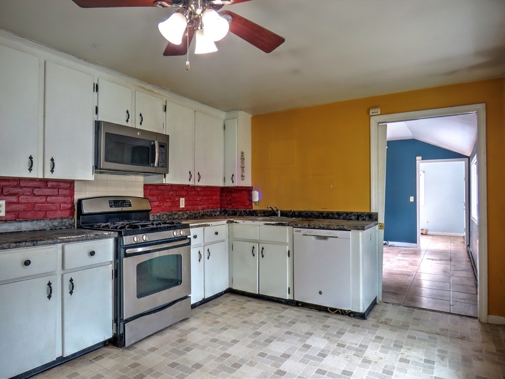 24 Estes Road Hanover, MA 02339 - Photo 7 of 27 a kitchen with stainless steel appliances granite countertop a stove a sink and a microwave