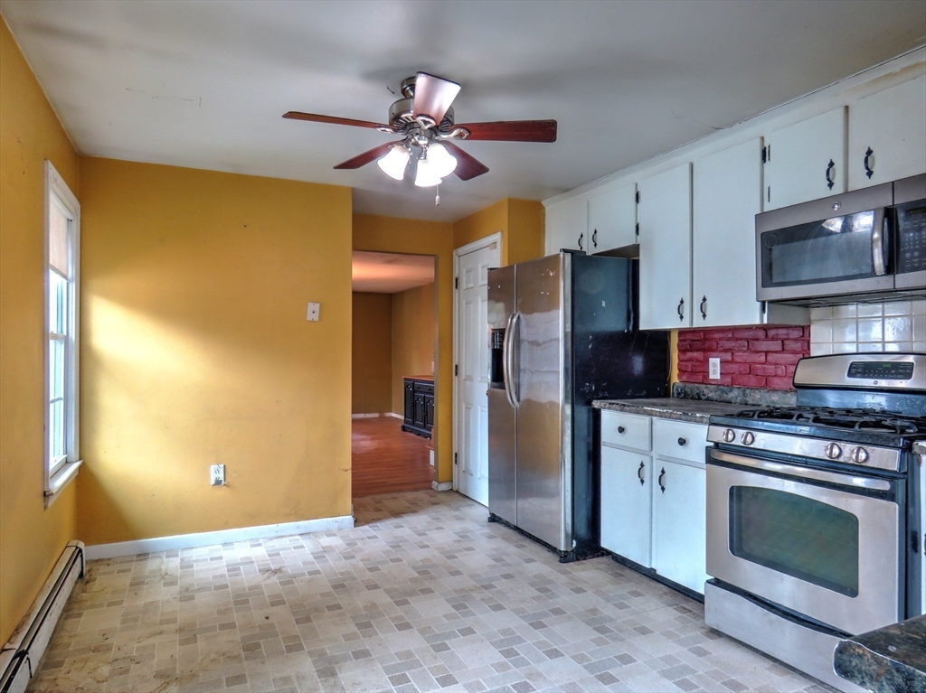 24 Estes Road Hanover, MA 02339 - Photo 8 of 27 a kitchen with stainless steel appliances granite countertop a stove a sink and a refrigerator