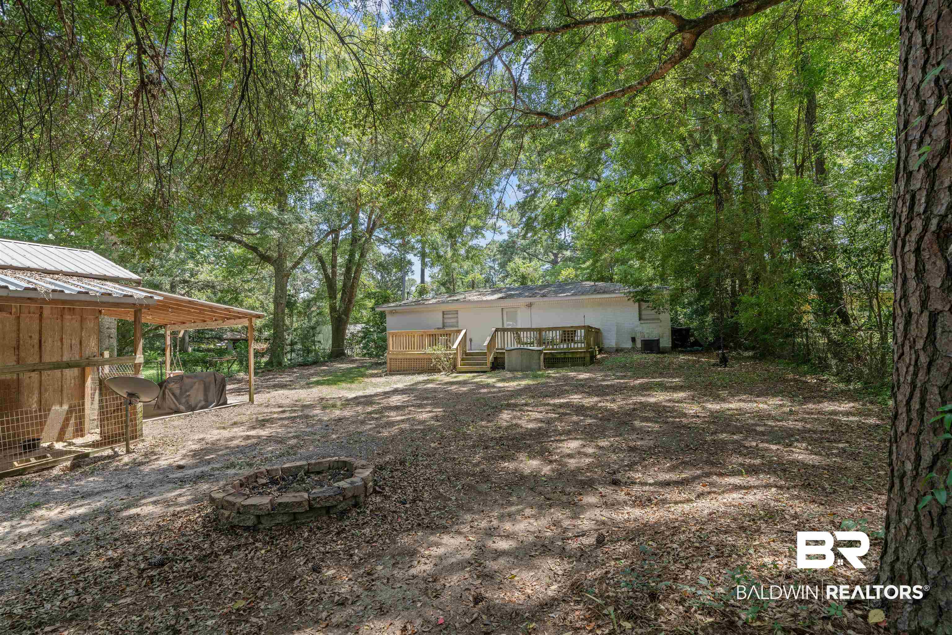 922 Dauphine Circle Daphne, AL 36526 - Photo 19 of 29 View of yard featuring a fire pit and a wooden deck