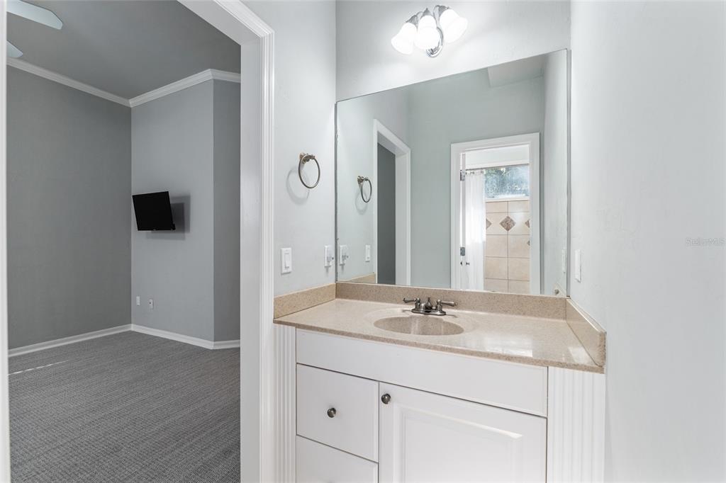 10614 Southwest 15th Lane Gainesville, FL 32607 - Photo 62 of 85 a bathroom with a sink a light fixture and a mirror