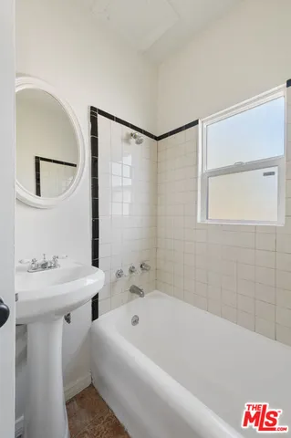 a bathroom with a bathtub and a sink
