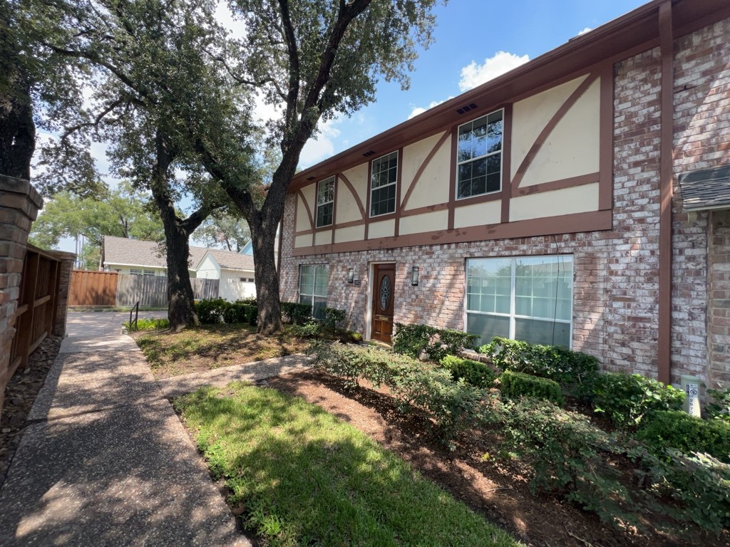 a brick building with a tree in front of it