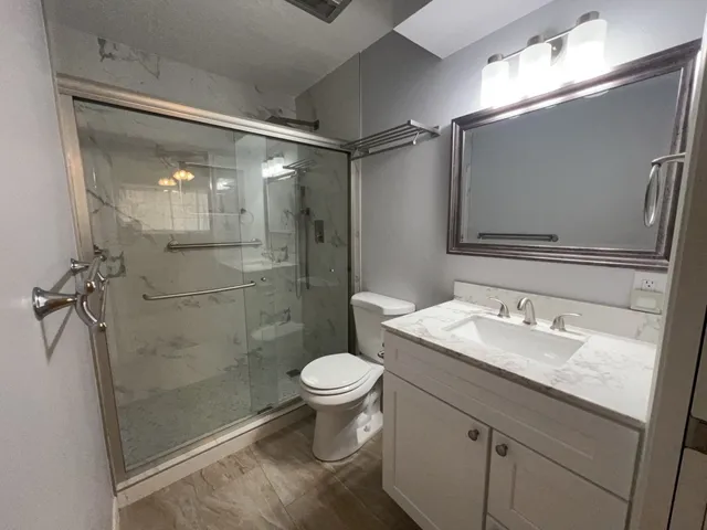 a bathroom with a sink toilet and shower