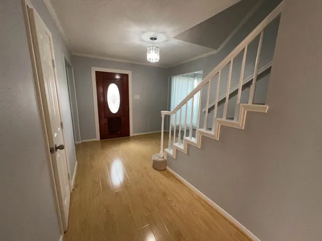 a view of entryway and hall with wooden floor