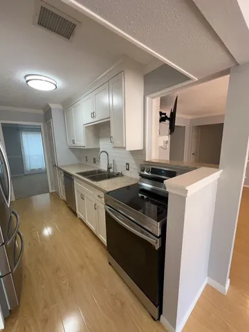 a kitchen with a stove and a sink