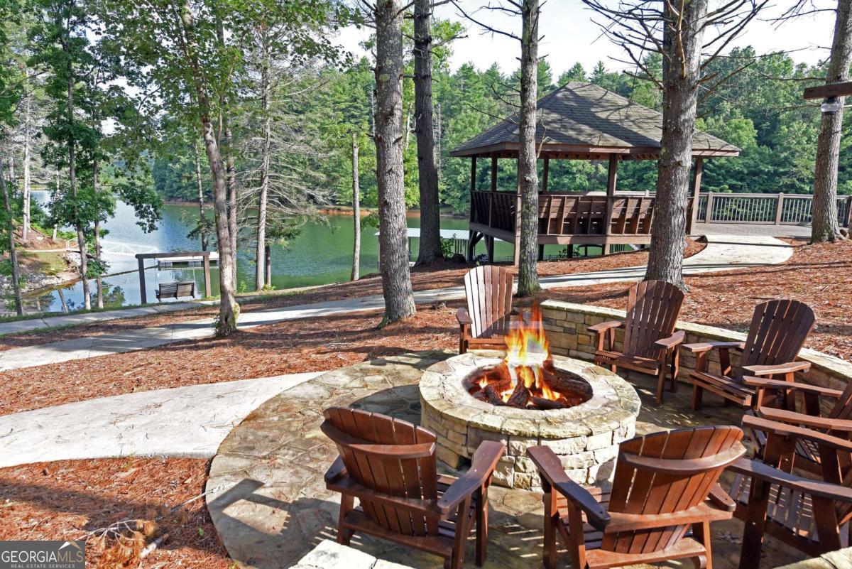 Lot 59 Ridge Peak View Blairsville, GA 30512 - Photo 20 of 49 a patio with a table and chairs and a fire pit
