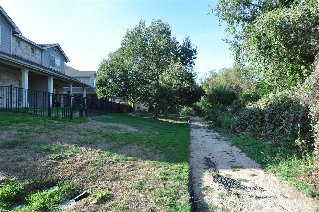 1900 Scofield Ridge Parkway, Unit 5403 Austin, TX 78727 - Photo 22 of 26 a backyard of a house with plants and large trees
