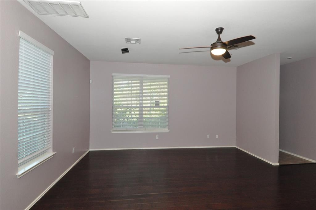 1900 Scofield Ridge Parkway, Unit 5403 Austin, TX 78727 - Photo 6 of 26 an empty room with wooden floor fan and windows
