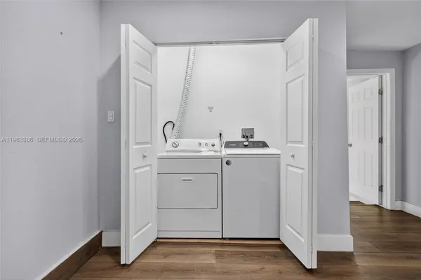 a utility room with cabinets washer and dryer