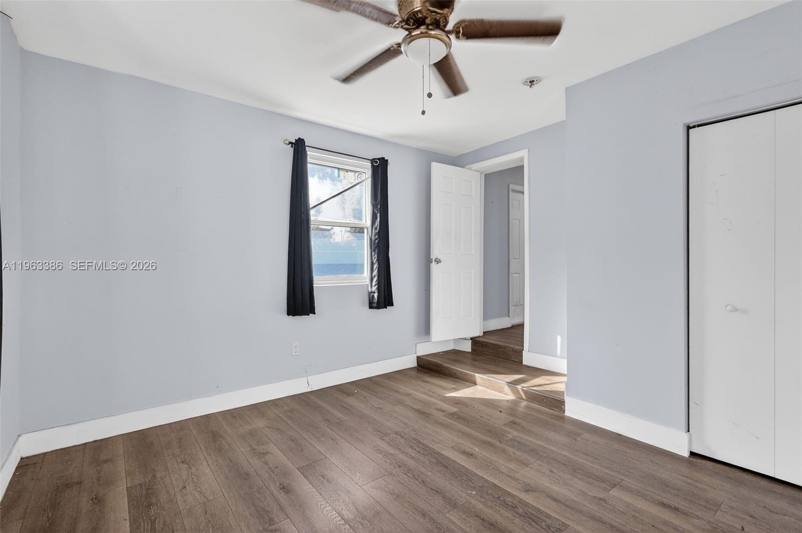 1880 Northwest 69th Street Miami, FL 33147 - Photo 14 of 19 a view of an empty room with wooden floor