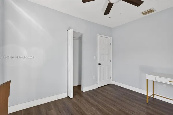a view of an empty room with wooden floor