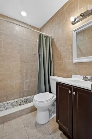 a bathroom with a sink toilet and shower