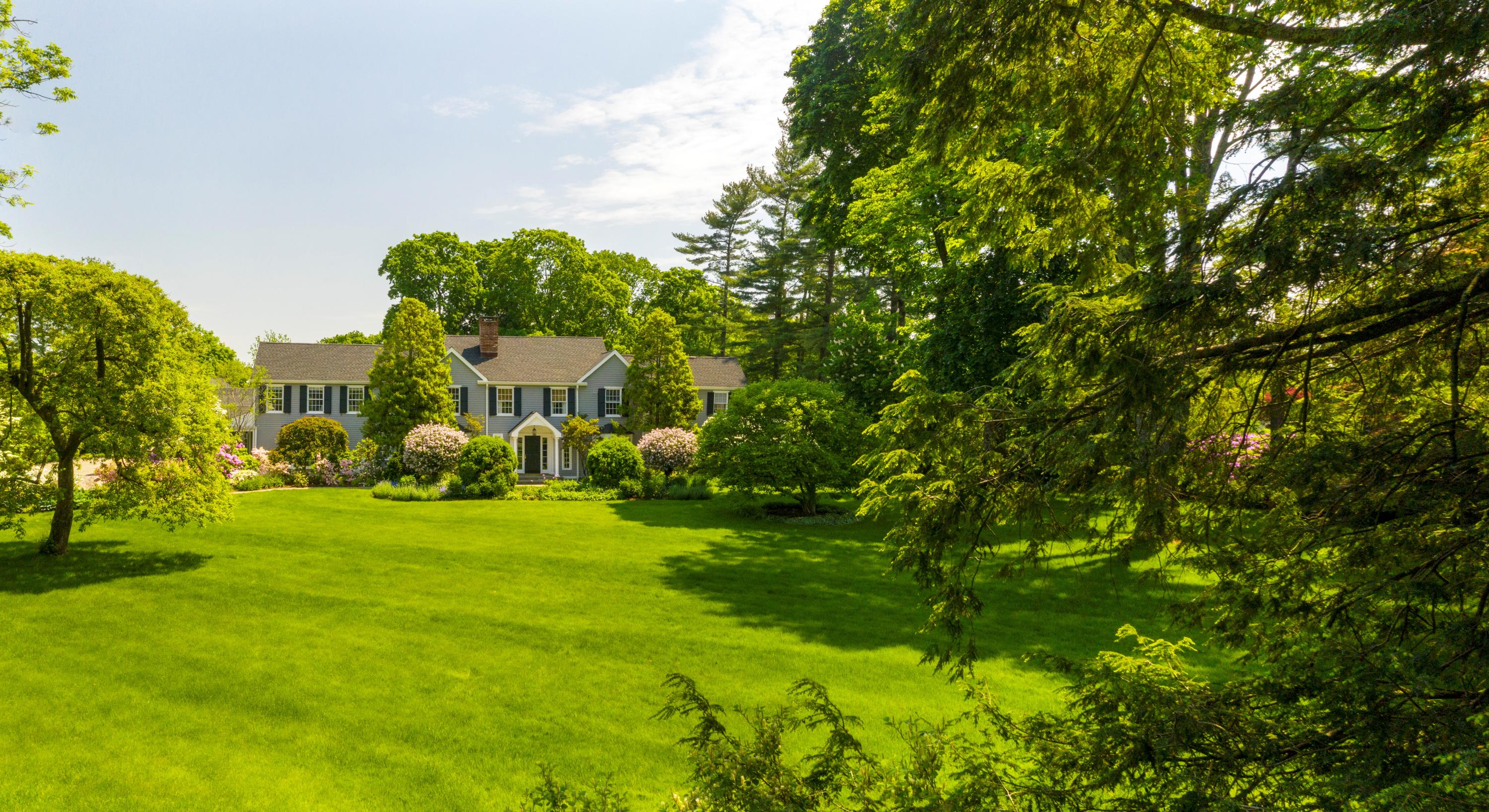 35 Rosebrook Road New Canaan, CT 06840 - Photo 1 of 38 a backyard of a house with a garden and plants