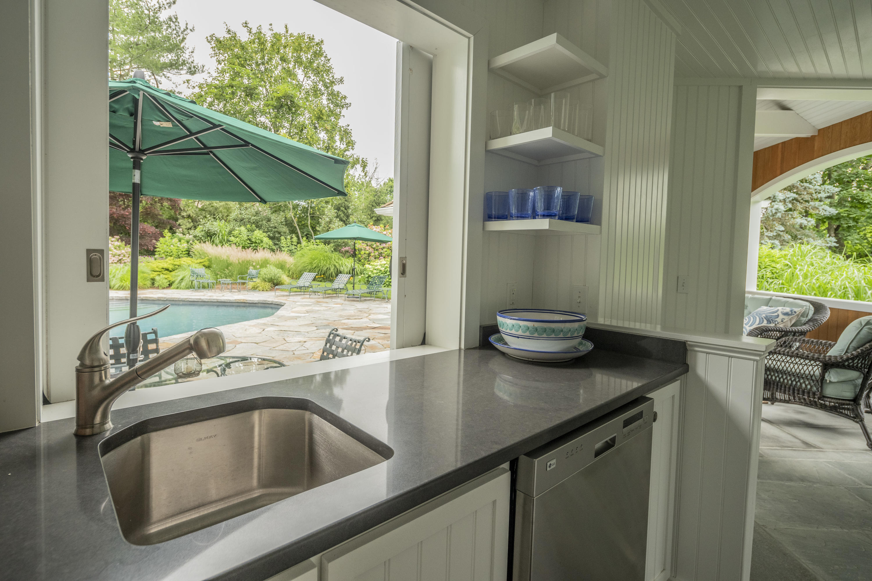 35 Rosebrook Road New Canaan, CT 06840 - Photo 36 of 38 a kitchen with a sink a stove and a microwave