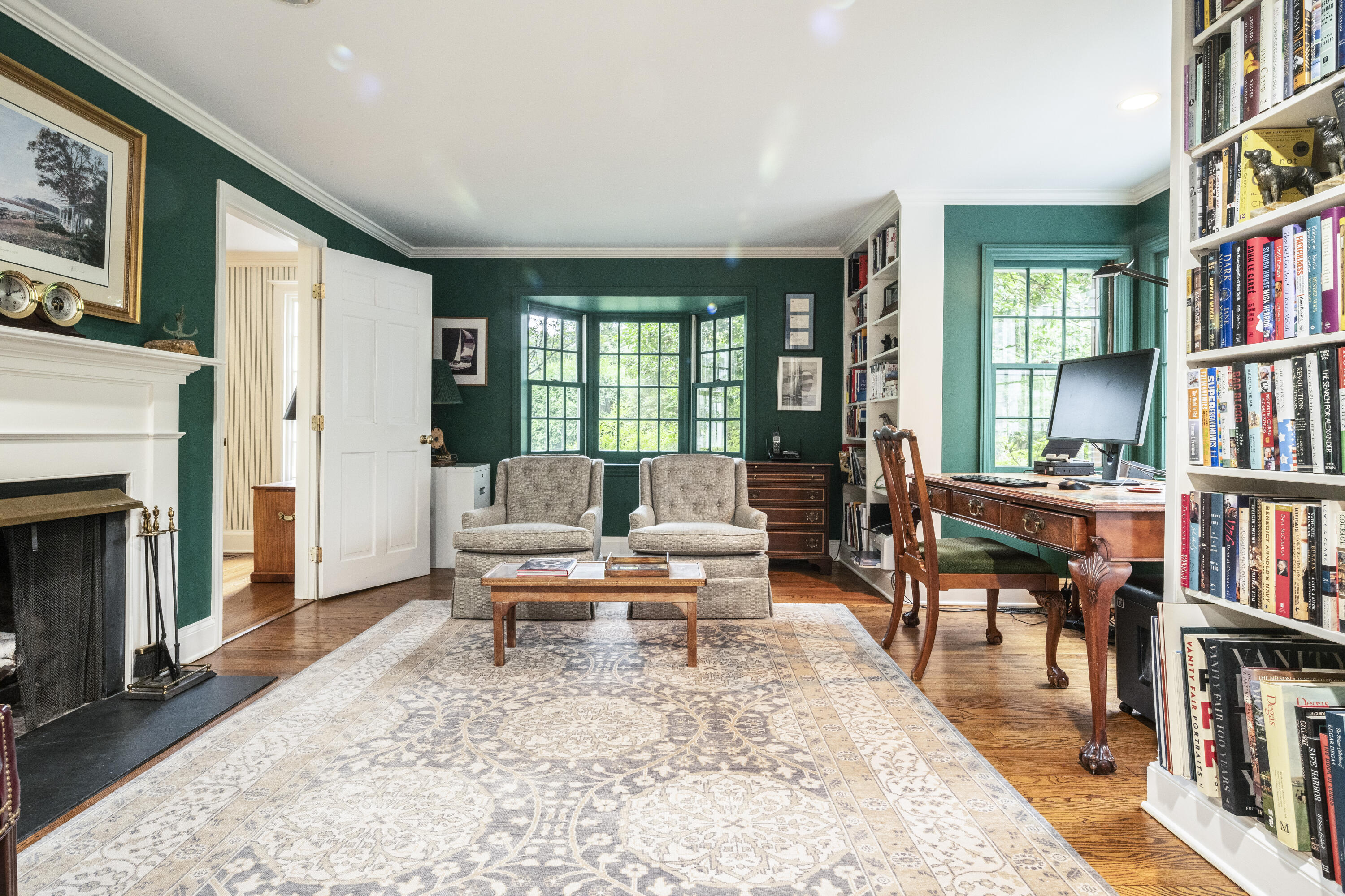 35 Rosebrook Road New Canaan, CT 06840 - Photo 6 of 38 a living room with furniture a bookshelf and a book shelf