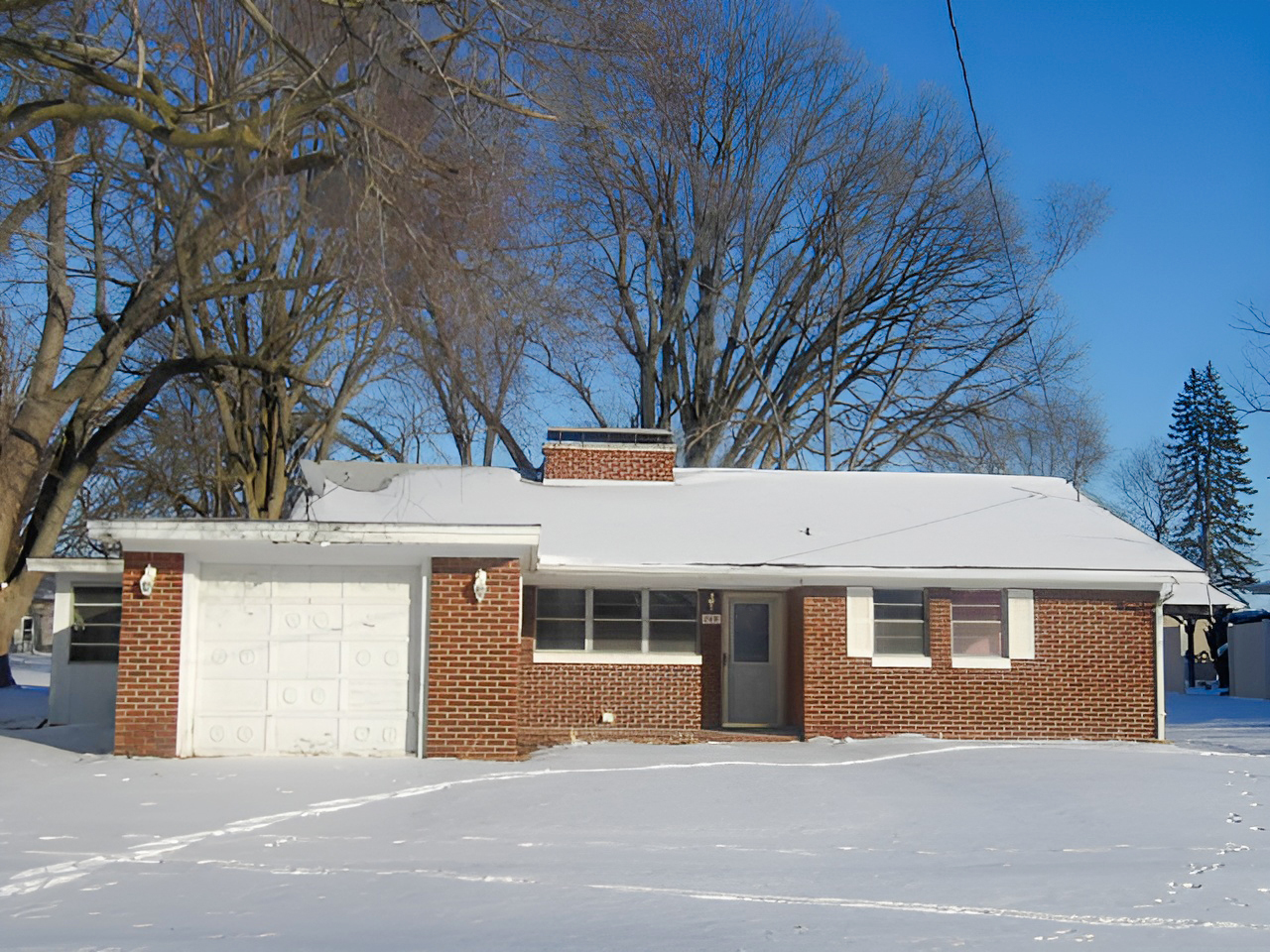 108 North Locust Street Maroa, IL 61756 - Photo 1 of 13 a front view of a house with a garage