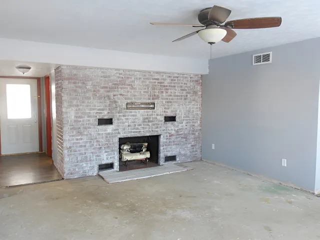 an empty room with windows and entrance