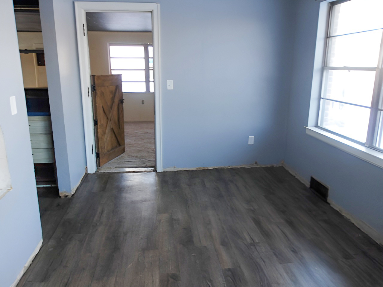 108 North Locust Street Maroa, IL 61756 - Photo 8 of 13 an empty room with wooden floor and a window