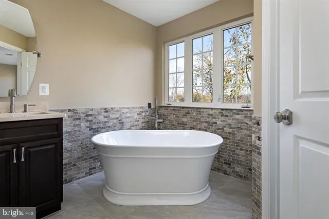 a white bath tub sitting in a bathroom