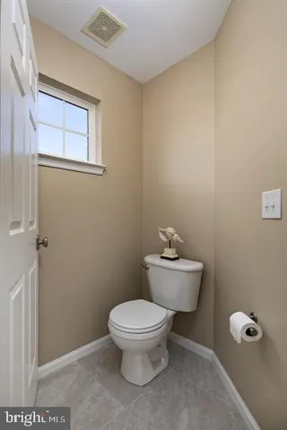 a white toilet sitting next to a bathroom sink
