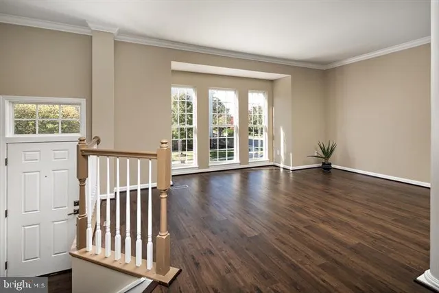 a view of a room with wooden floor and a window