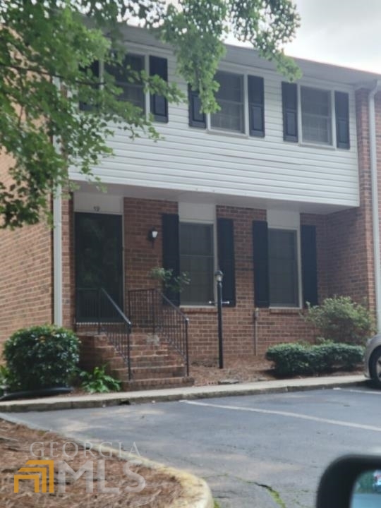 6520 Roswell Road Northeast, Unit 59 Atlanta, GA 30328 - Photo 1 of 1 a view of a house with a yard and large tree