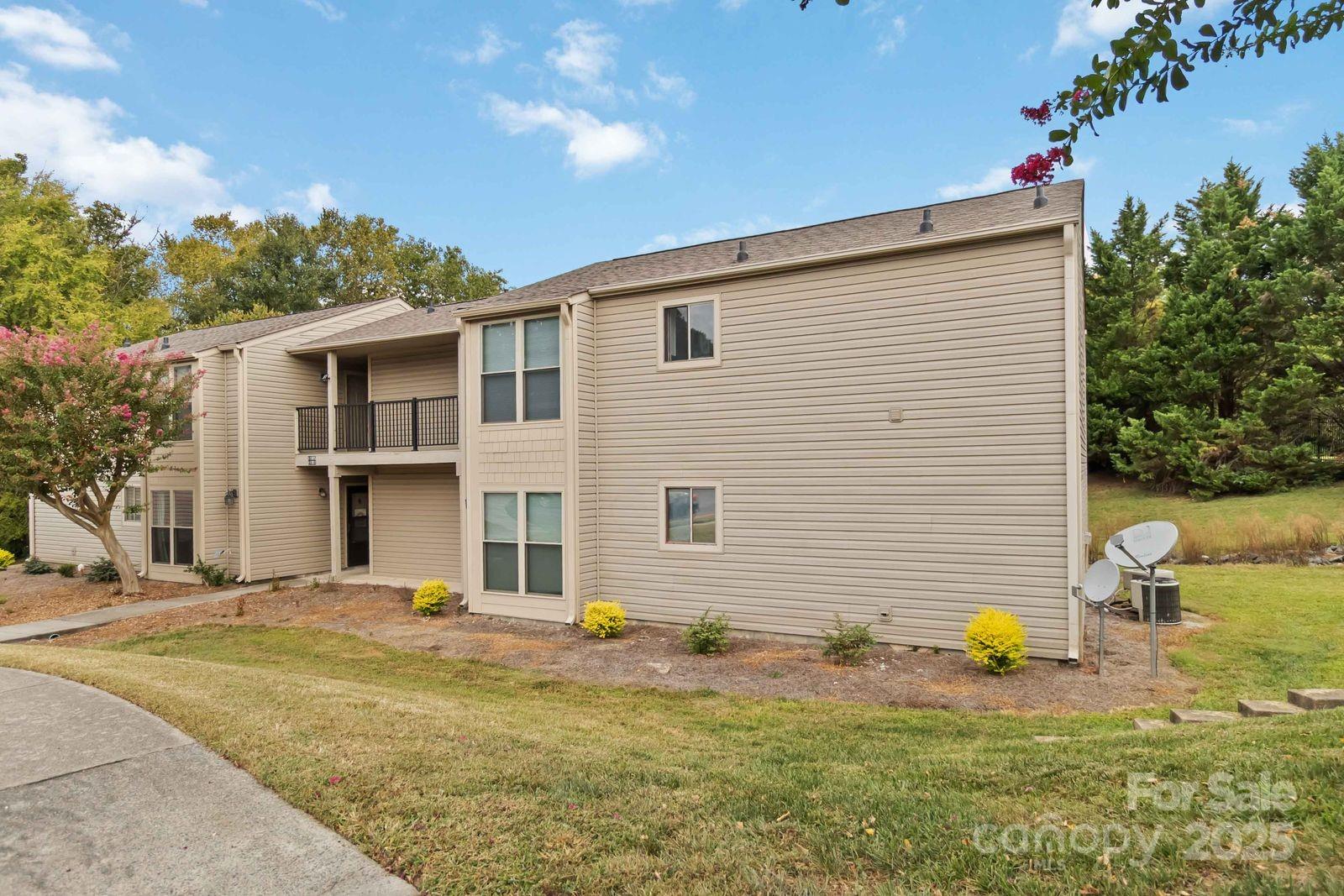 a backyard of a house with table and chairs