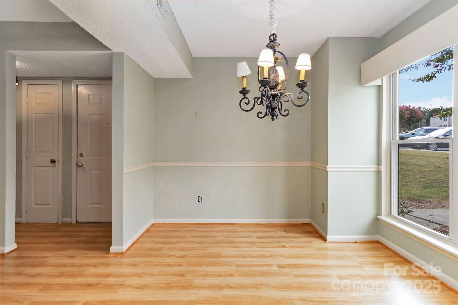 11001 Running Ridge Rd. Charlotte, NC 28226 - Photo 15 of 38 a view of empty room with wooden floor and fan