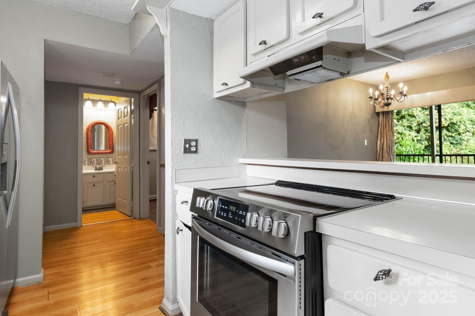 11001 Running Ridge Rd. Charlotte, NC 28226 - Photo 19 of 38 a kitchen with a stove and a microwave