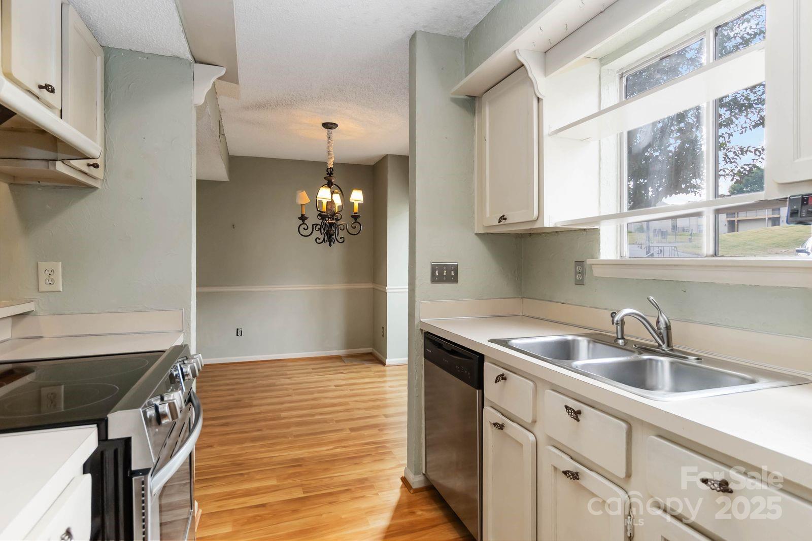 11001 Running Ridge Rd. Charlotte, NC 28226 - Photo 20 of 38 a kitchen with a sink and cabinets