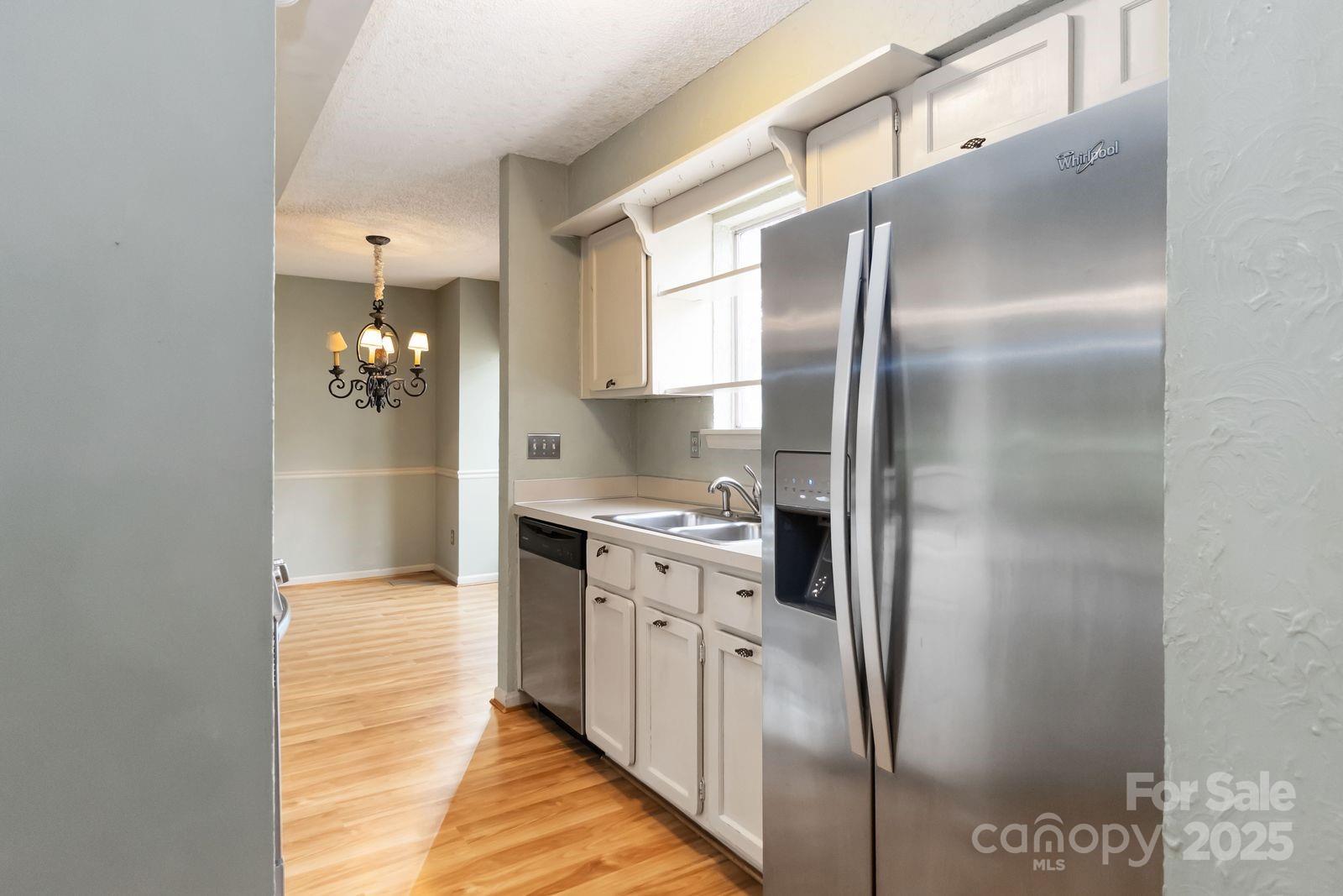 11001 Running Ridge Rd. Charlotte, NC 28226 - Photo 21 of 38 a kitchen with stainless steel appliances granite countertop a refrigerator and a sink