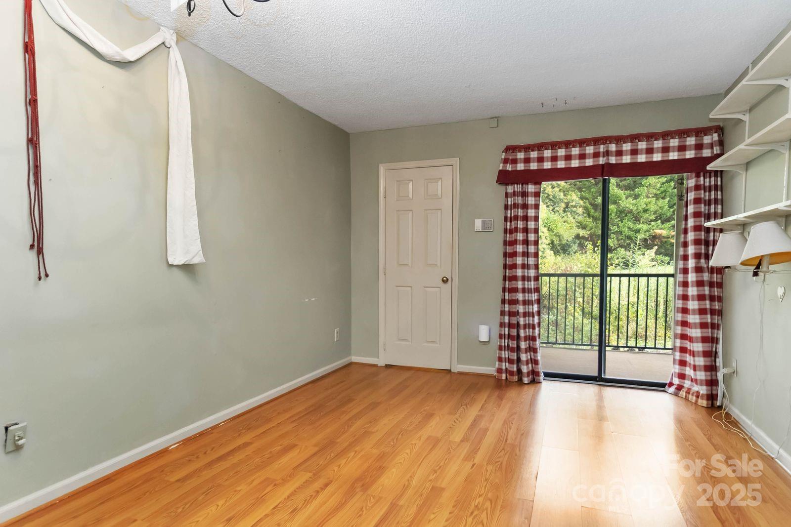 11001 Running Ridge Rd. Charlotte, NC 28226 - Photo 24 of 38 a view of empty room with wooden floor and fan