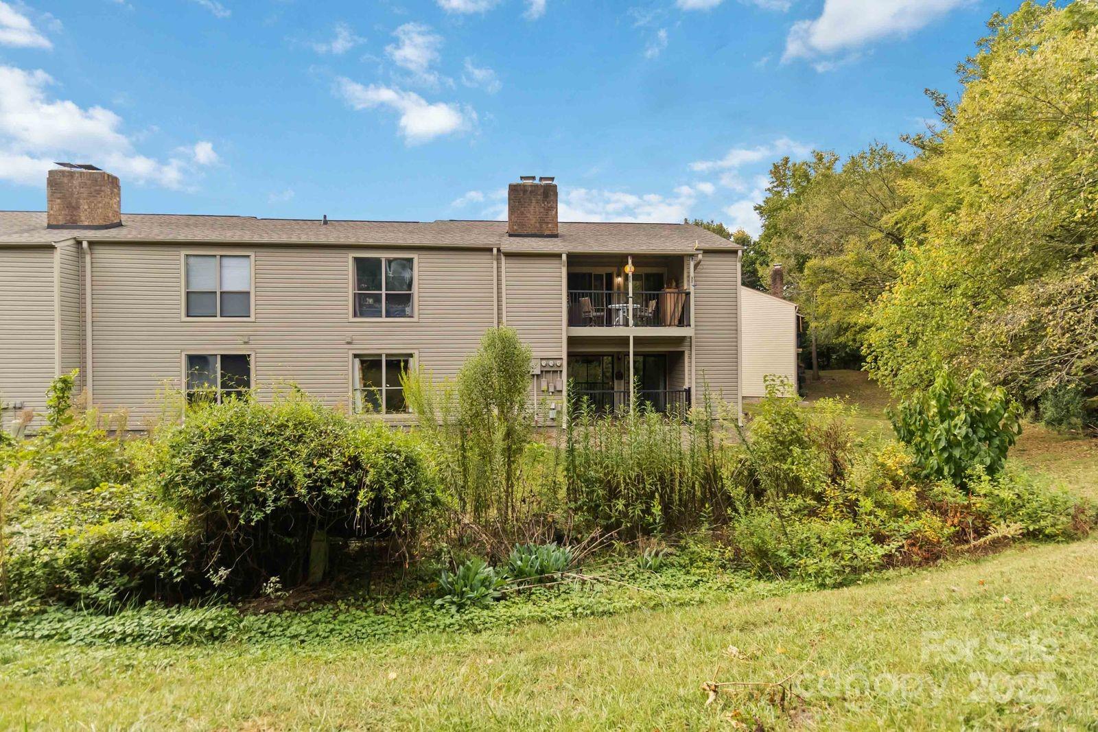 11001 Running Ridge Rd. Charlotte, NC 28226 - Photo 35 of 38 a backyard of a house with plants and outdoor seating