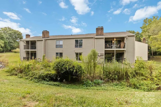 an aerial view of a house with swimming pool and a yard
