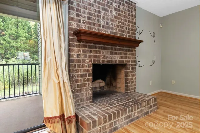 a view of a room with wooden floor and ceiling fan