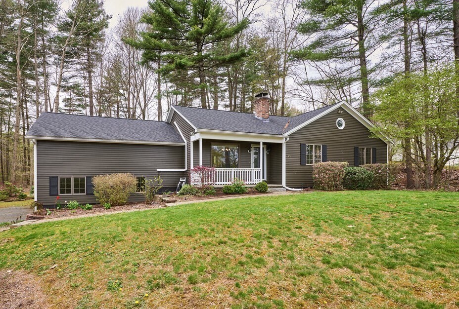 21 Collette Road Sturbridge, MA 01518 - Photo 1 of 42 a front view of a house with a yard and trees