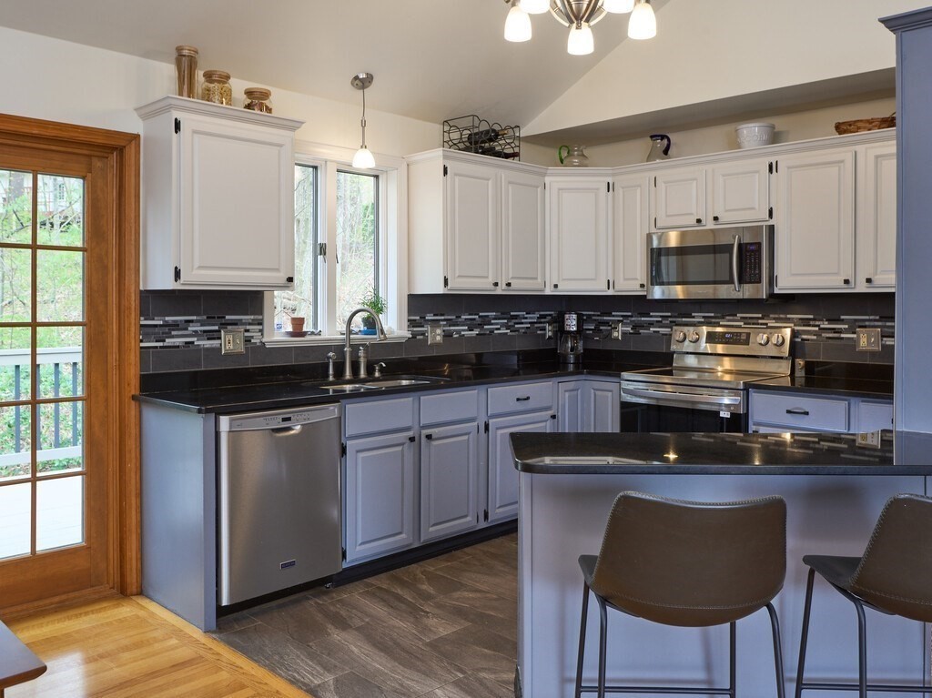 21 Collette Road Sturbridge, MA 01518 - Photo 12 of 42 a kitchen with stainless steel appliances granite countertop a stove a sink and a microwave