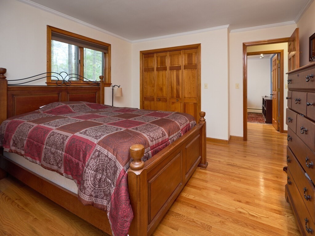 21 Collette Road Sturbridge, MA 01518 - Photo 20 of 42 a bed sitting in a bedroom next to a window