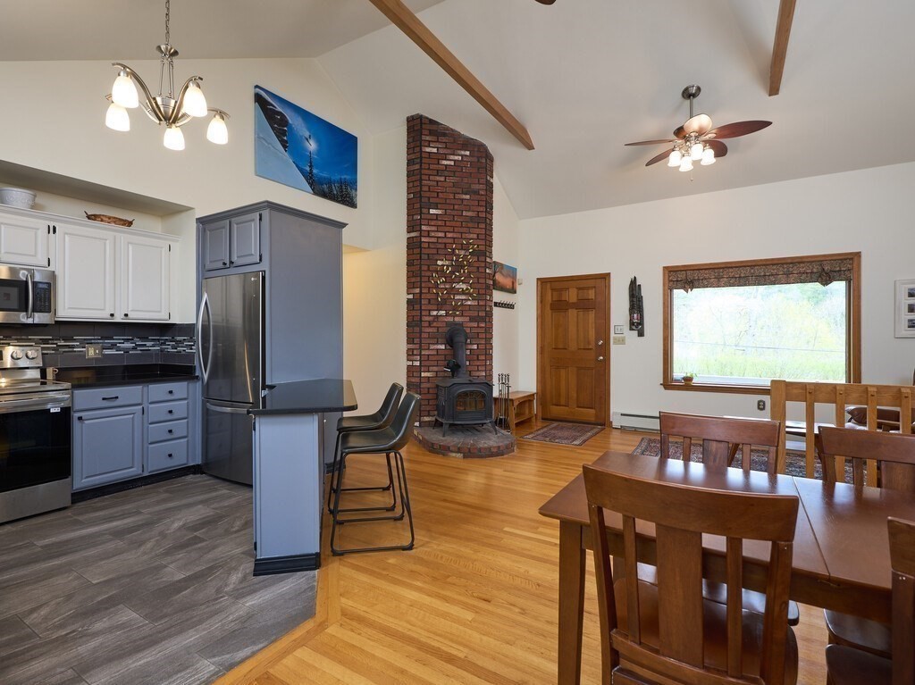 21 Collette Road Sturbridge, MA 01518 - Photo 7 of 42 a kitchen with granite countertop a refrigerator stove top oven and cabinets
